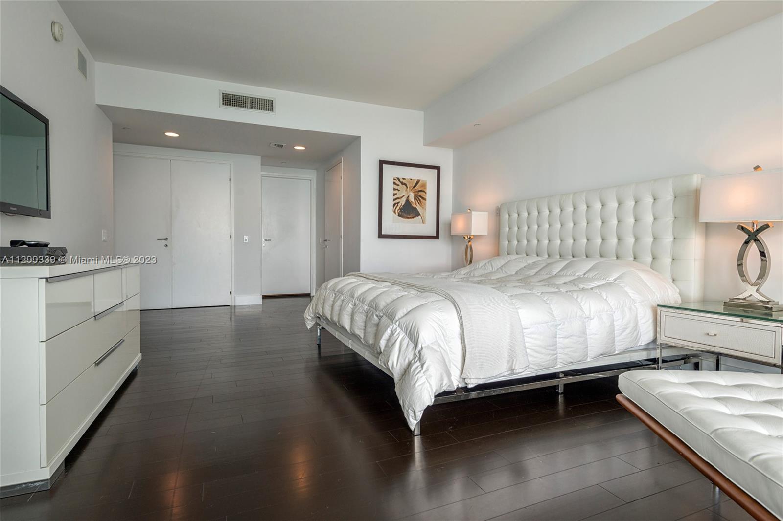 450 Alton Road, Unit 3603 Miami Beach, FL 33139 - Photo 13 of 25 a bedroom with a bed and a dresser