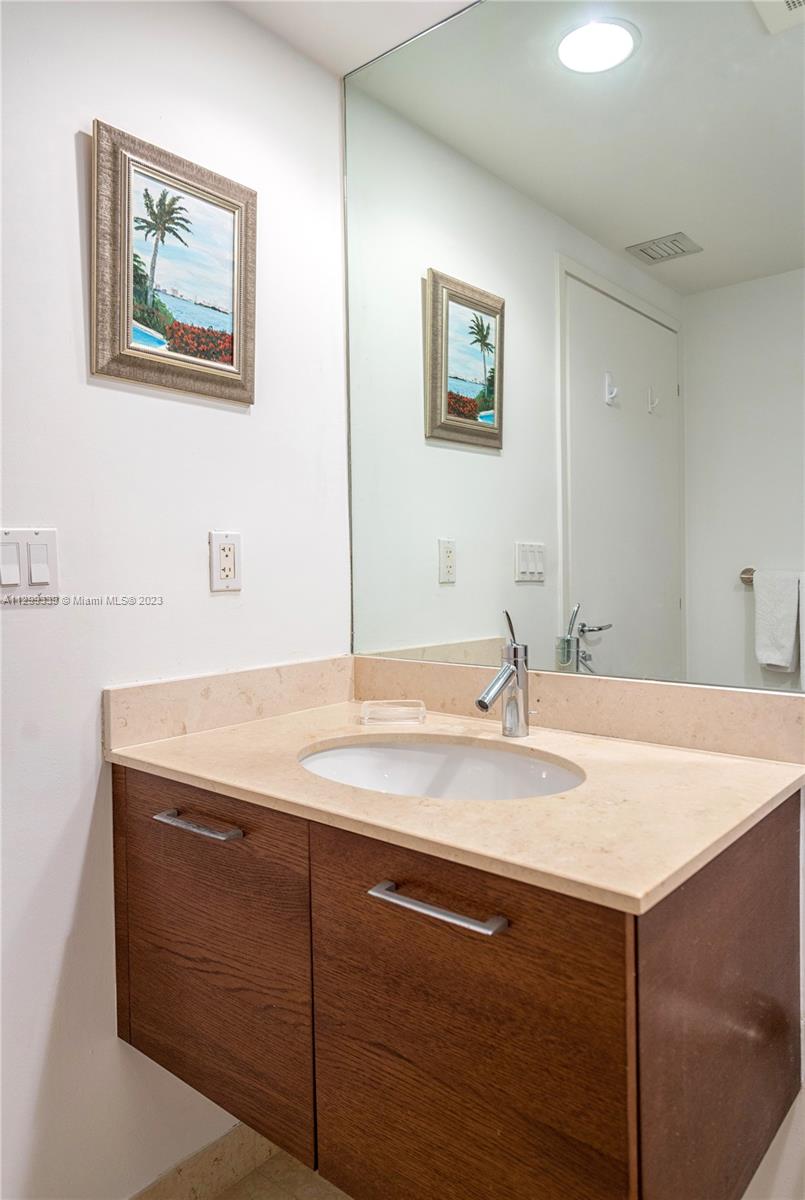 450 Alton Road, Unit 3603 Miami Beach, FL 33139 - Photo 25 of 25 a bathroom with a sink and a mirror
