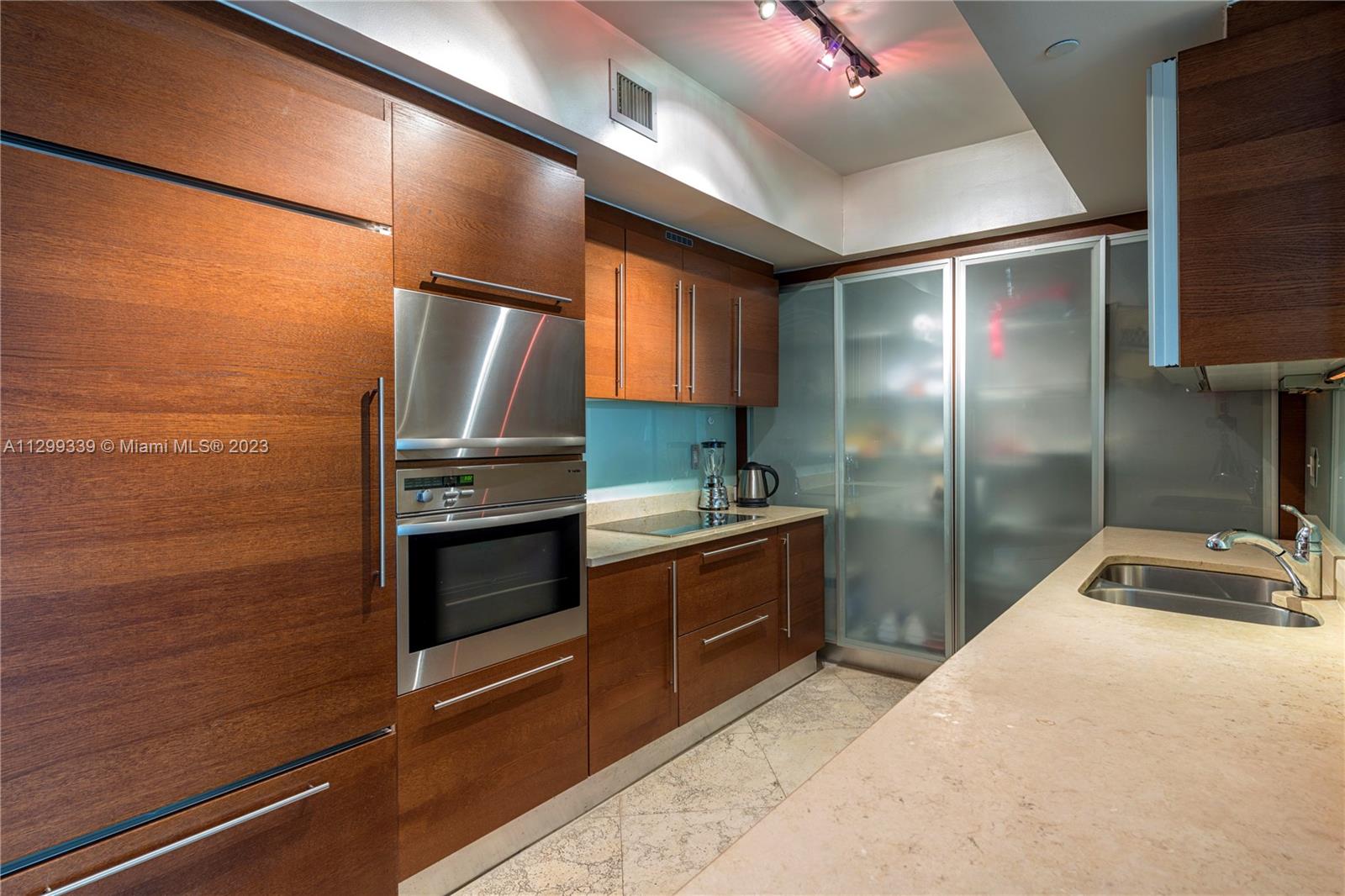 450 Alton Road, Unit 3603 Miami Beach, FL 33139 - Photo 6 of 25 a kitchen with granite countertop stainless steel appliances and counter space