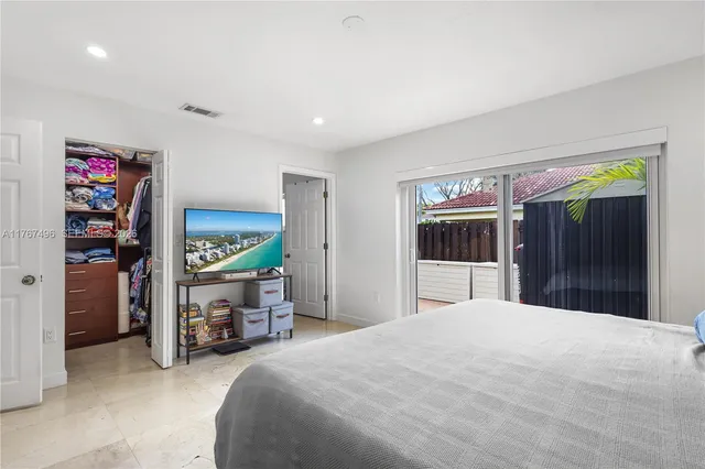 a bedroom with a bed and a walk in closet