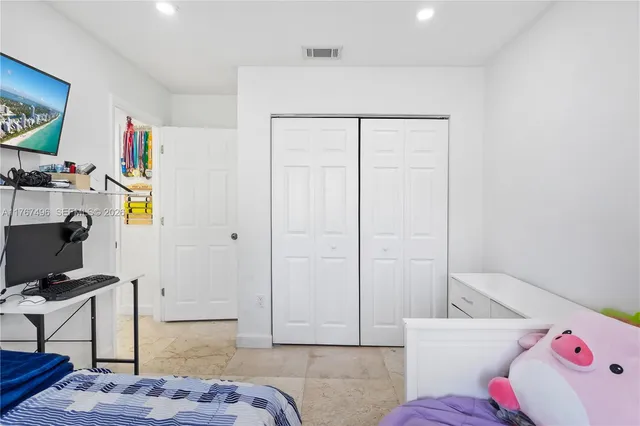 a bedroom with a bed and a couch