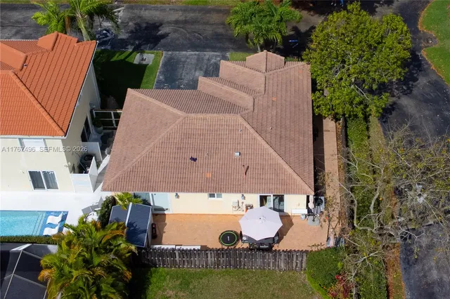 an aerial view of a house with yard swimming pool and outdoor seating