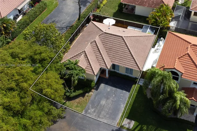 an aerial view of a house with garden space and plants