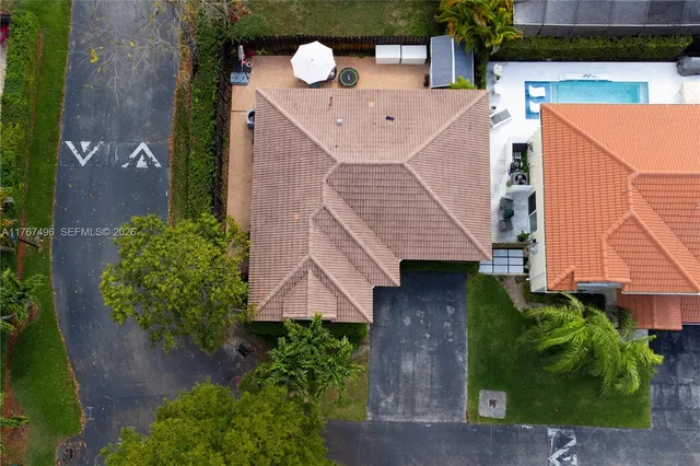 an aerial view of a house with a backyard space
