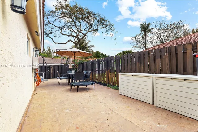 a view of a chairs and tables in the back yard of the house