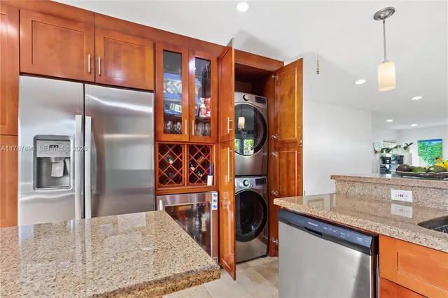 a kitchen with stainless steel appliances granite countertop a refrigerator and a sink