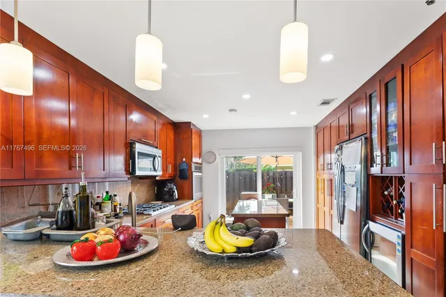 a kitchen with sink refrigerator and cabinets