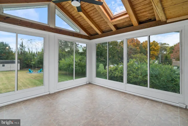 a view of a room that has wooden floor and window