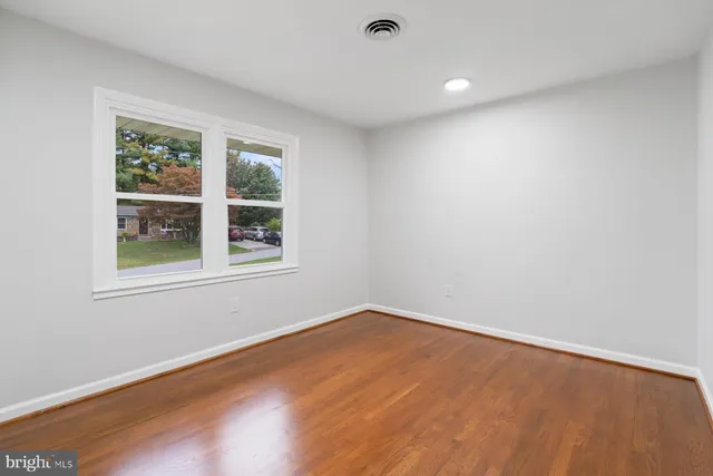 a view of a house with a yard and large tree