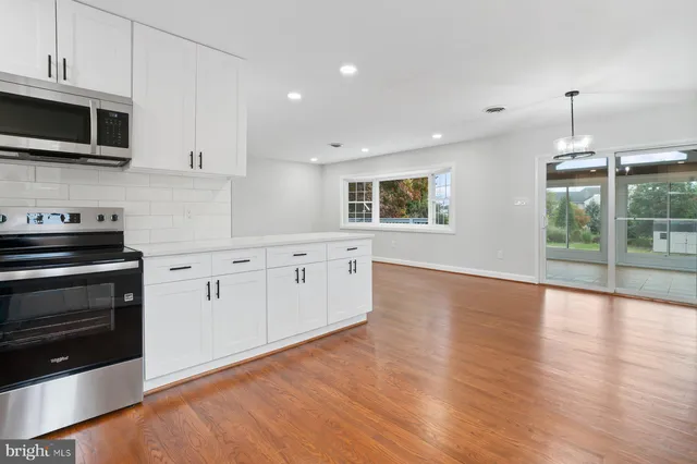 a bathroom with a granite countertop sink a toilet and mirror