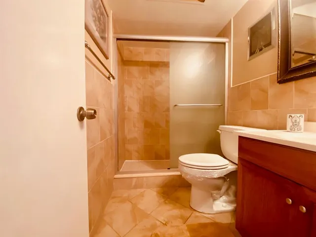 a bathroom with a toilet and a shower