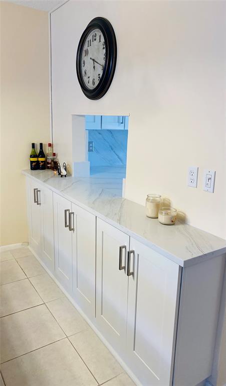 Northeast Boca Raton Boca Raton, FL 33431 - Photo 14 of 32 a kitchen with a sink a clock and cabinets