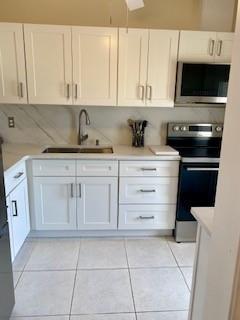 Northeast Boca Raton Boca Raton, FL 33431 - Photo 2 of 32 a kitchen with granite countertop white cabinets stainless steel appliances and a sink