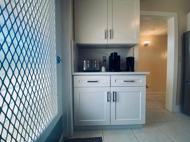 a kitchen with white cabinets