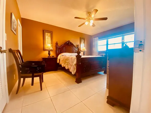 a bed room with a bed and a chair