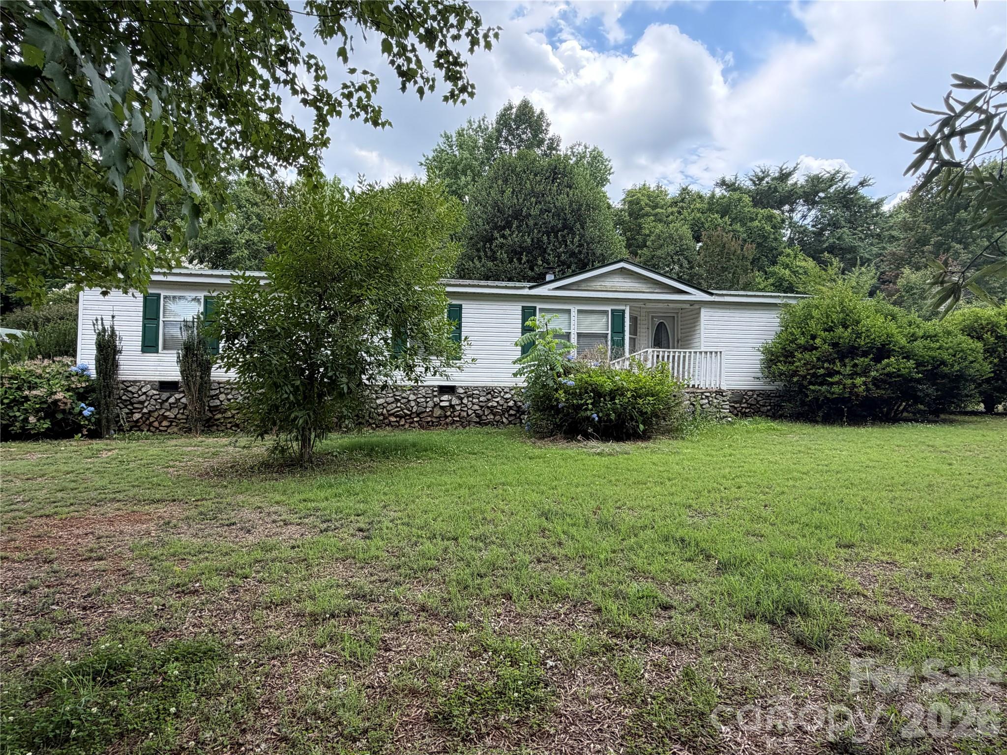43702 Cypress Crossing Road New London, NC 28127 - Photo 2 of 12 a view of a house in front of a big yard with large trees
