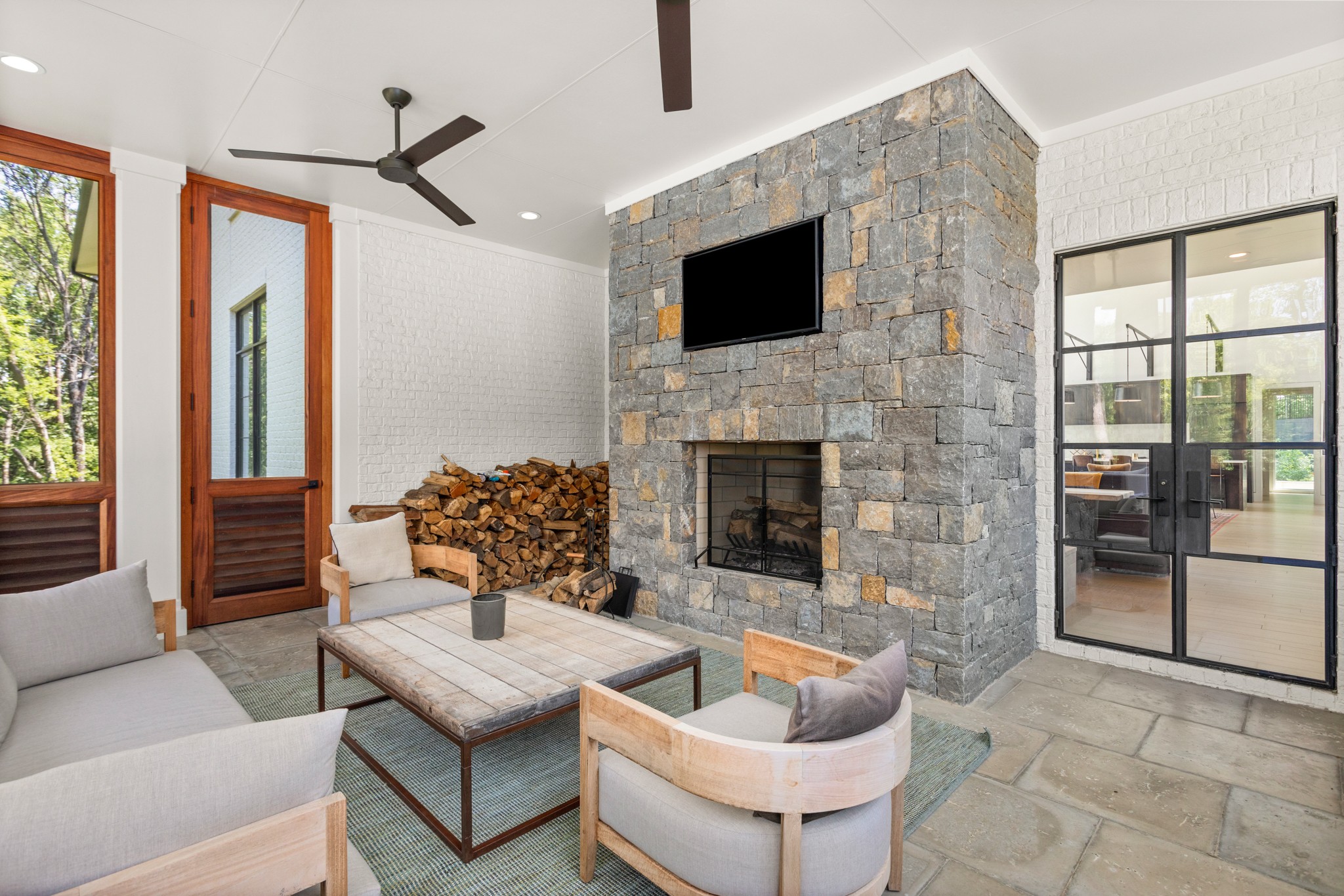 960 Overton Lea Road Nashville, TN 37220 - Photo 36 of 50 a living room with furniture a fireplace and a flat screen tv