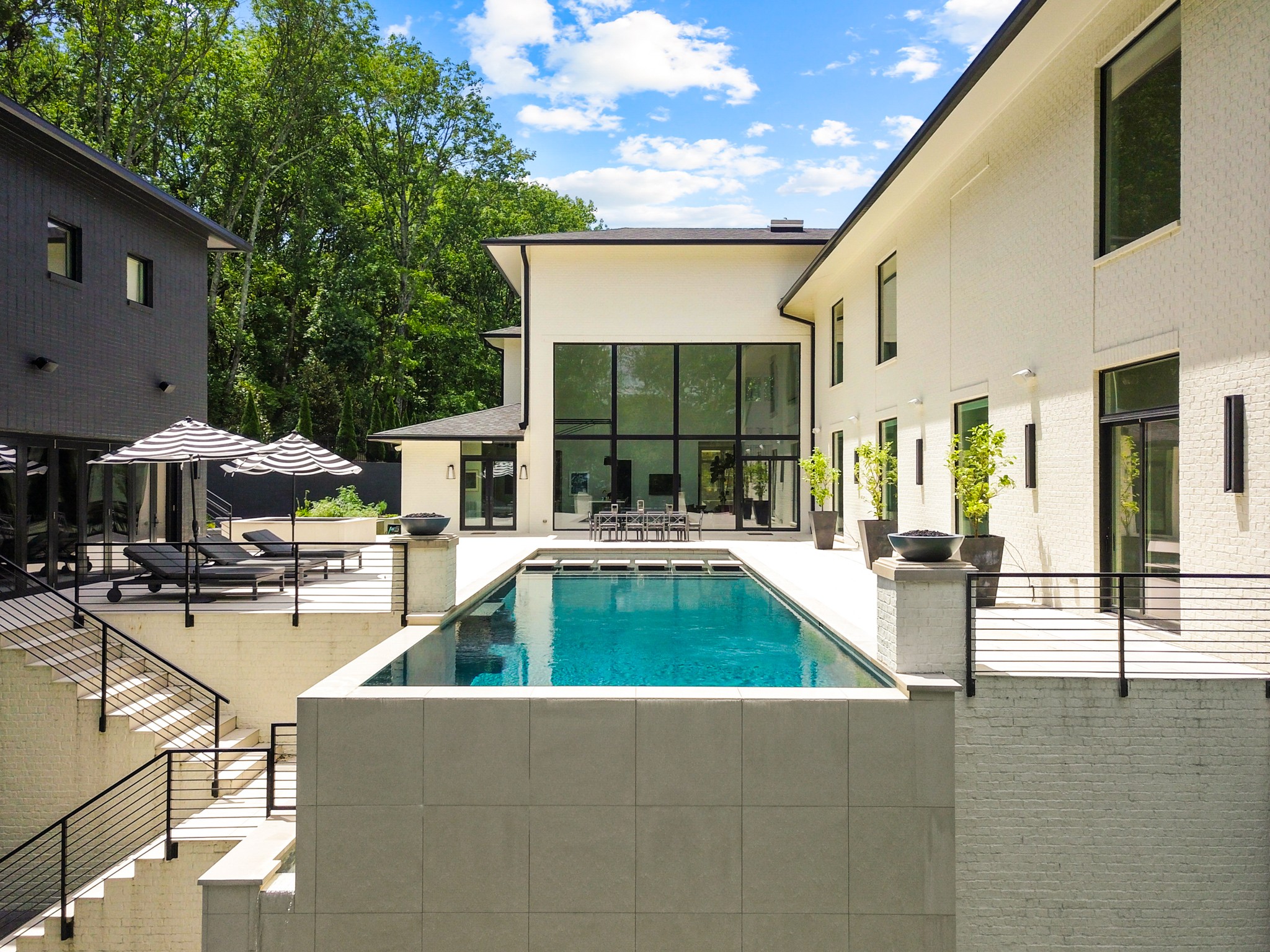 960 Overton Lea Road Nashville, TN 37220 - Photo 37 of 50 a view of open kitchen with table and chairs under an umbrella