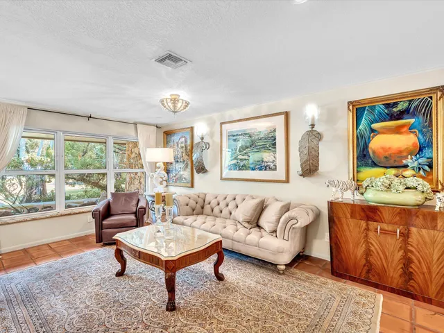 a living room with furniture and a book shelf