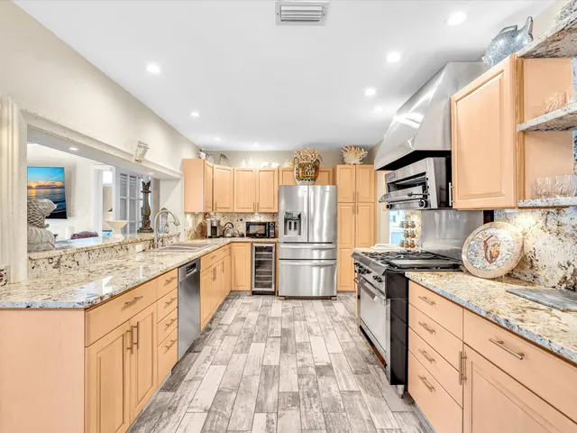 a living room with furniture a flat screen tv and a large window