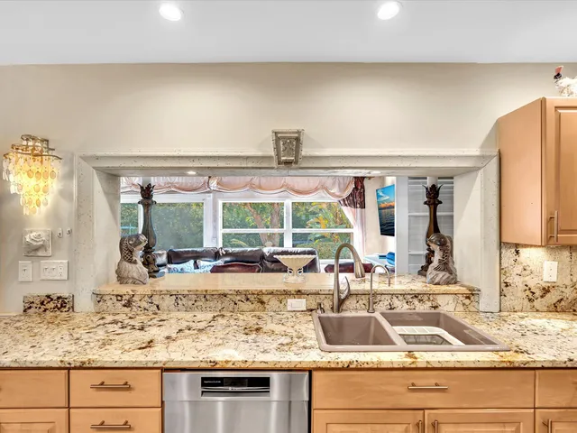 a backyard of a house with fountain and outdoor seating