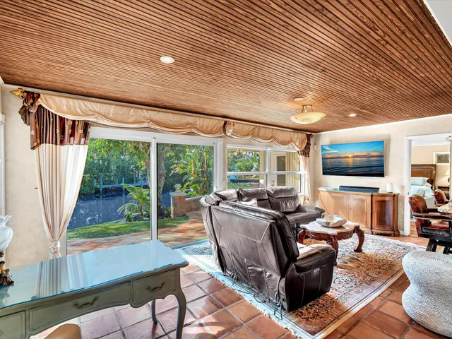 a view of a backyard with table and chairs and a large tree