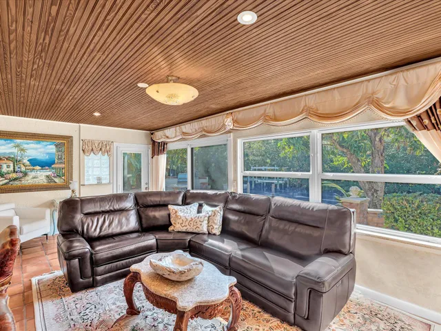 a bathroom with a granite countertop sink mirror and a window