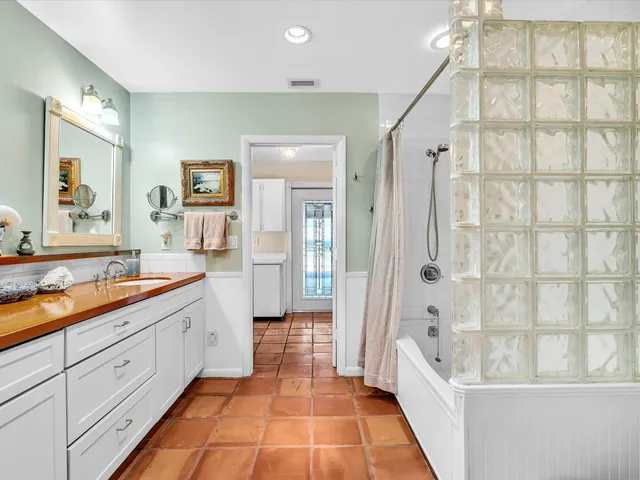 a view of a house with a big yard plants and large trees