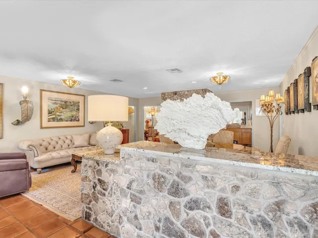 a living room with furniture a rug and a large window