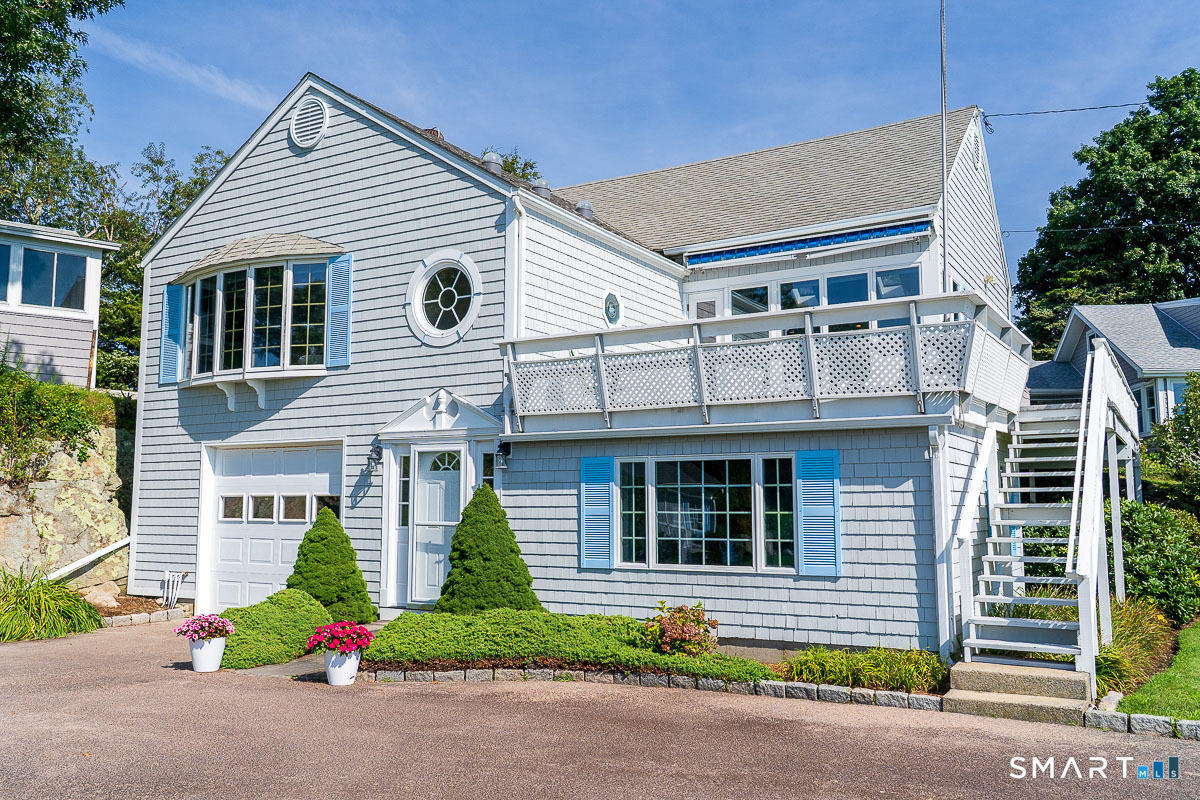 132 Latimer Point Road, Unit 132 Stonington, CT 06378 - Photo 7 of 38 Front view of 132 Latimer Point Road with side stair to upper deck area outside open kitchen.
