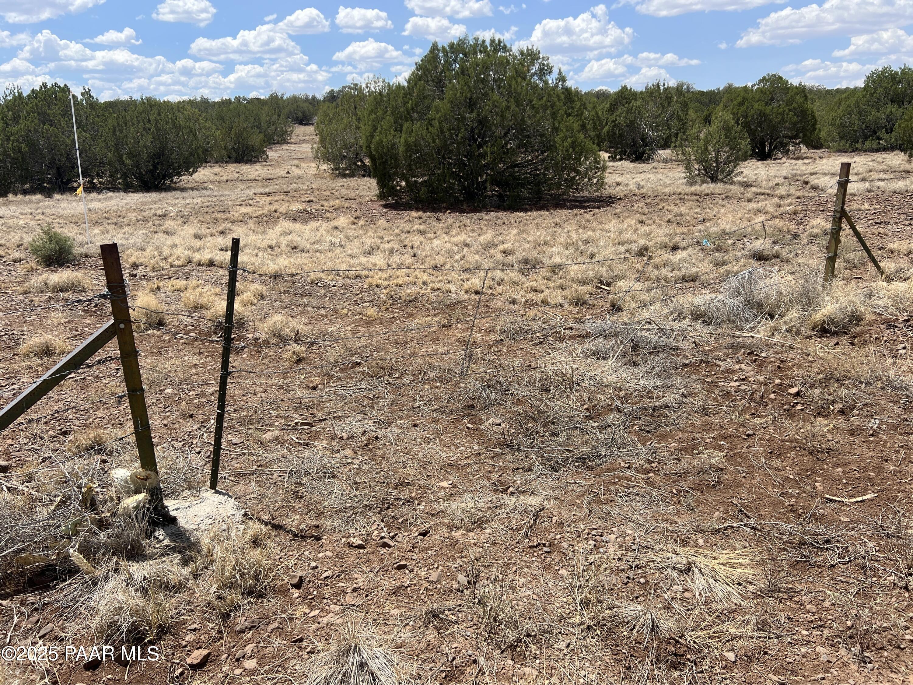 66 West Old Rte 66 Ash Fork, AZ 86320 - Photo 6 of 19 a view of a dry yard with wooden fence