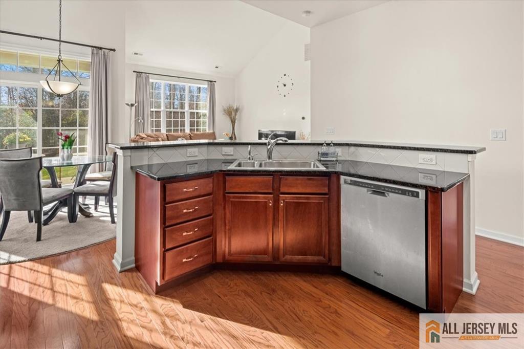 9 Bellingham Drive Kendall Park, NJ 08824 - Photo 14 of 65 a kitchen with granite countertop a sink cabinets and wooden floor