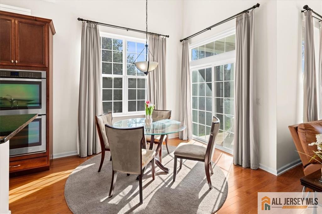 9 Bellingham Drive Kendall Park, NJ 08824 - Photo 18 of 65 a view of a dining room with furniture window and wooden floor