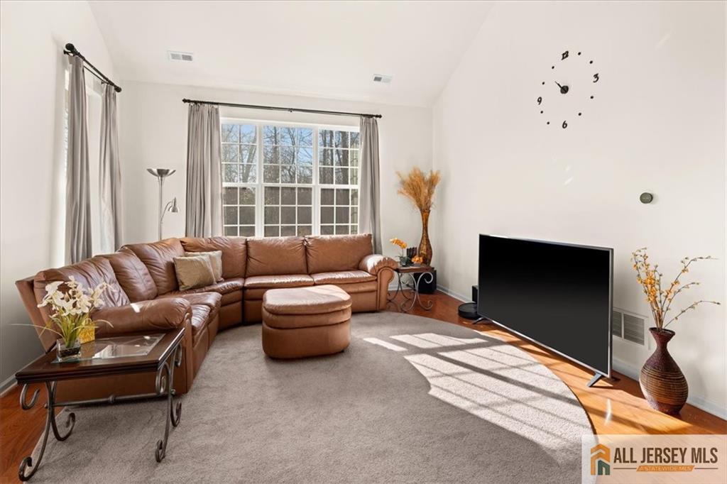 9 Bellingham Drive Kendall Park, NJ 08824 - Photo 19 of 65 a living room with furniture a flat screen tv and a window