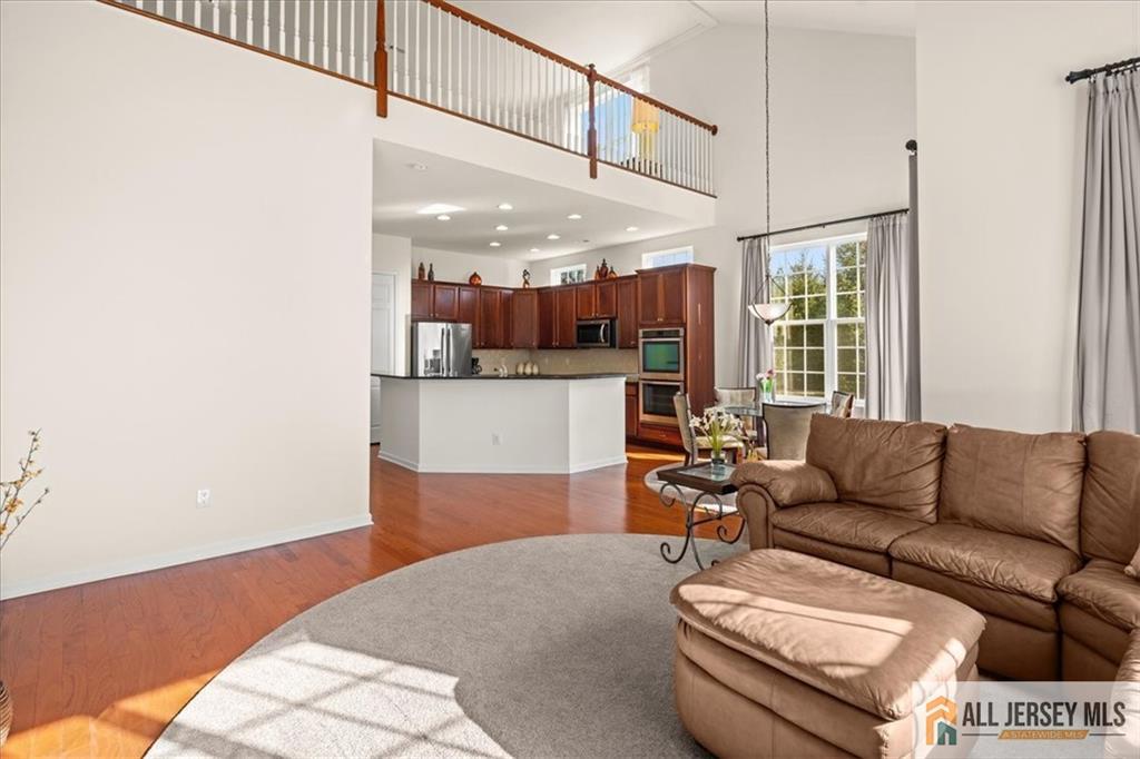 9 Bellingham Drive Kendall Park, NJ 08824 - Photo 21 of 65 a living room with furniture and kitchen view