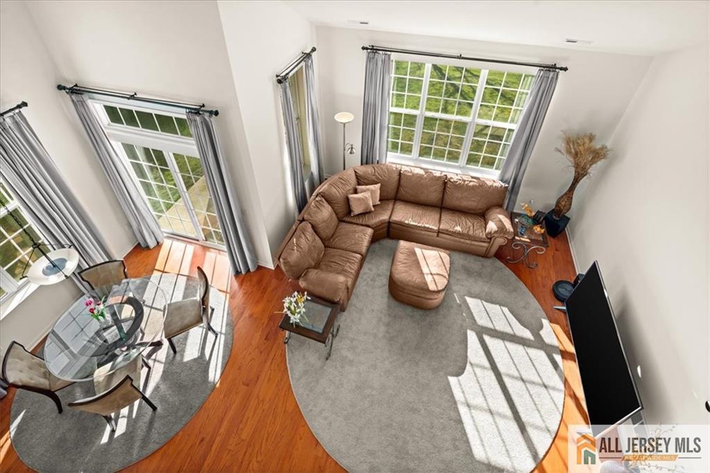 9 Bellingham Drive Kendall Park, NJ 08824 - Photo 29 of 65 a view of a living room with furniture and a floor to ceiling window
