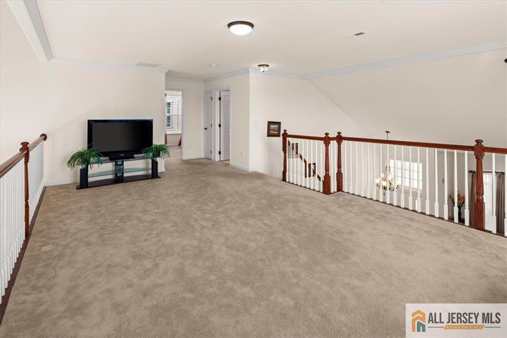 9 Bellingham Drive Kendall Park, NJ 08824 - Photo 32 of 65 a living room with furniture and a flat screen tv