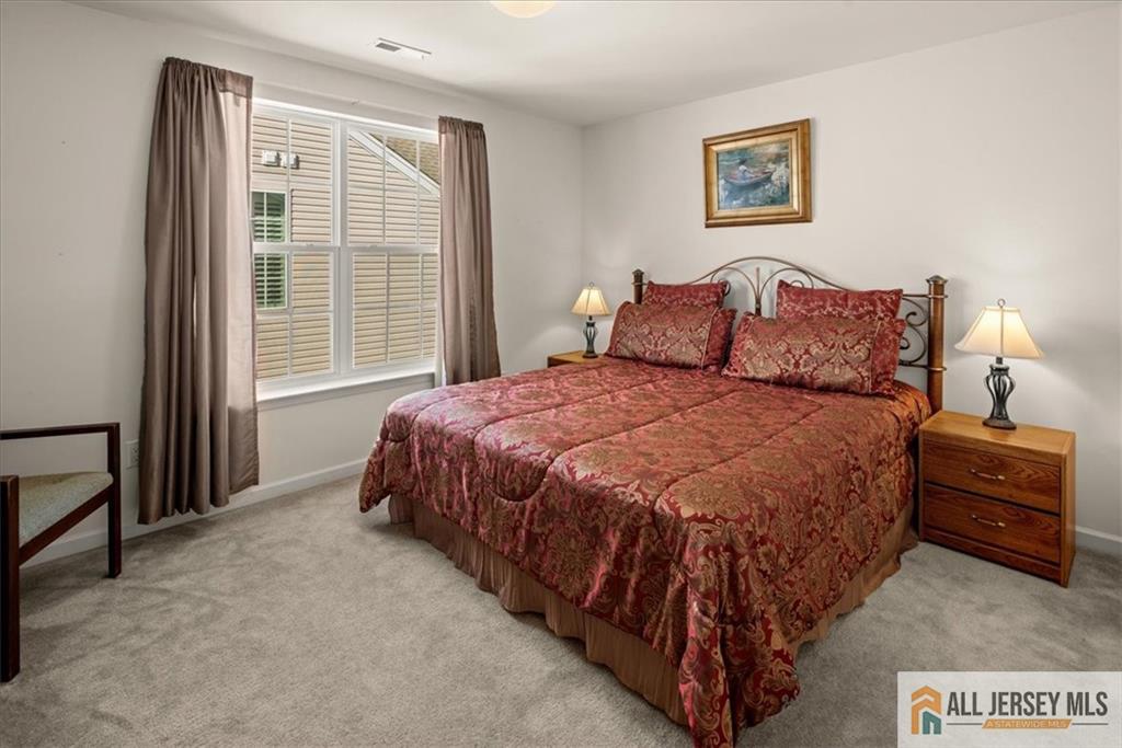 9 Bellingham Drive Kendall Park, NJ 08824 - Photo 33 of 65 a spacious bedroom with a bed and a window