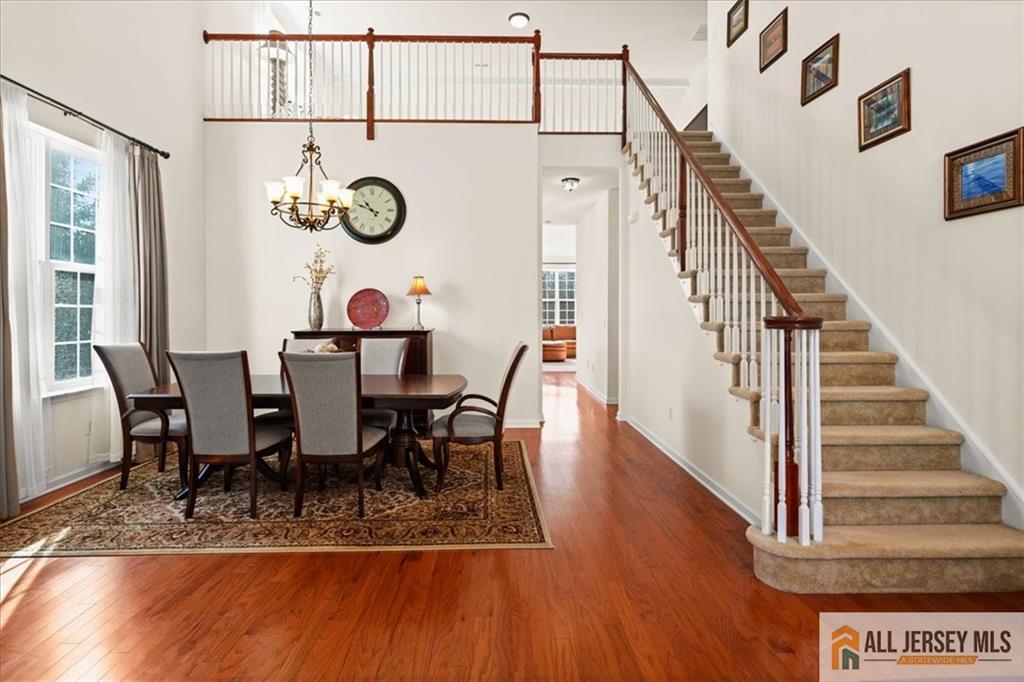 9 Bellingham Drive Kendall Park, NJ 08824 - Photo 9 of 65 a view of a dining room with furniture and wooden floor