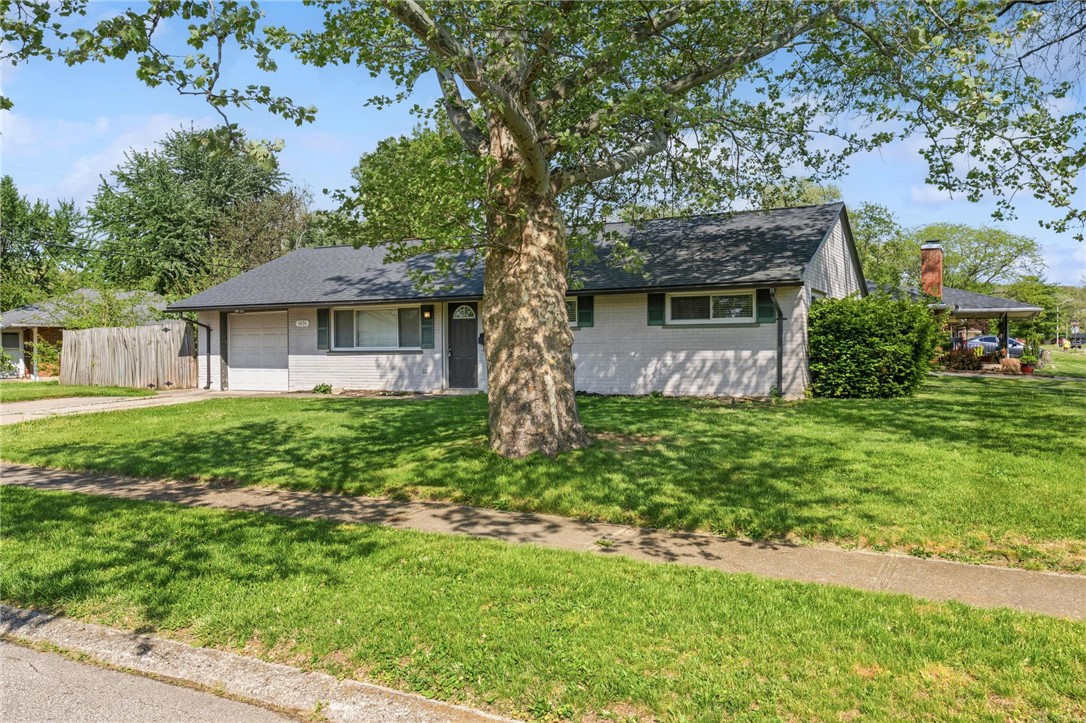 3890 Endover Road Dayton, OH 45439 - Photo 2 of 26 This charming residence offers a welcoming facade with lush landscaping and mature trees.