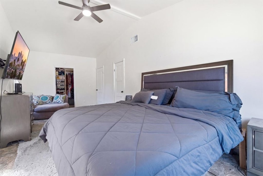 7959 Bothwell Road Reseda, CA 91335 - Photo 18 of 60 a bedroom with a large bed and a chandelier