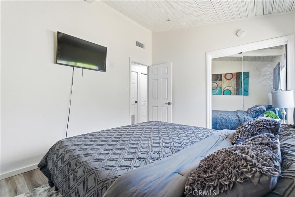 7959 Bothwell Road Reseda, CA 91335 - Photo 22 of 60 a bedroom with a bed and a flat screen tv