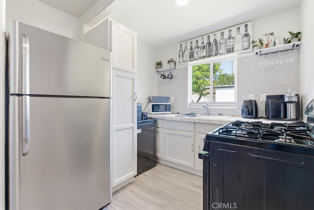 7959 Bothwell Road Reseda, CA 91335 - Photo 35 of 60 a kitchen with stainless steel appliances granite countertop a refrigerator sink a stove and a refrigerator