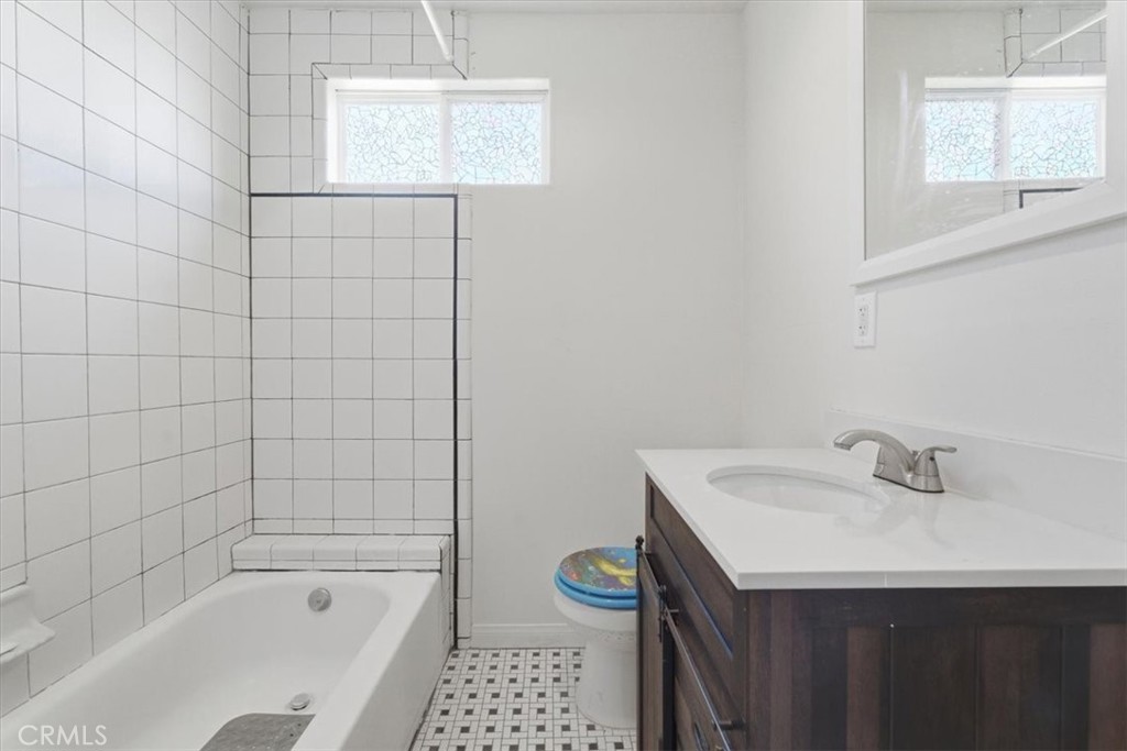 7959 Bothwell Road Reseda, CA 91335 - Photo 37 of 60 a bathroom with a sink a toilet and shower
