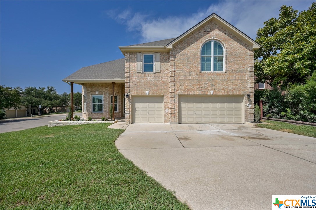 a front view of a house with a yard and garage