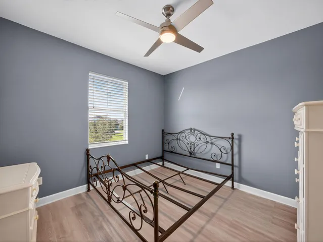 a front view of a house with a yard and potted plants