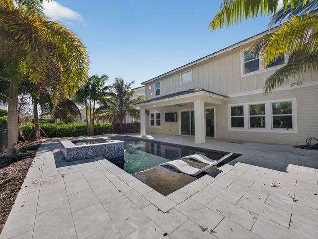 a view of a swimming pool and lounge chair
