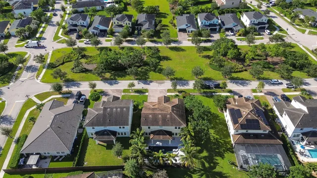an aerial view of a house with swimming pool and outdoor seating