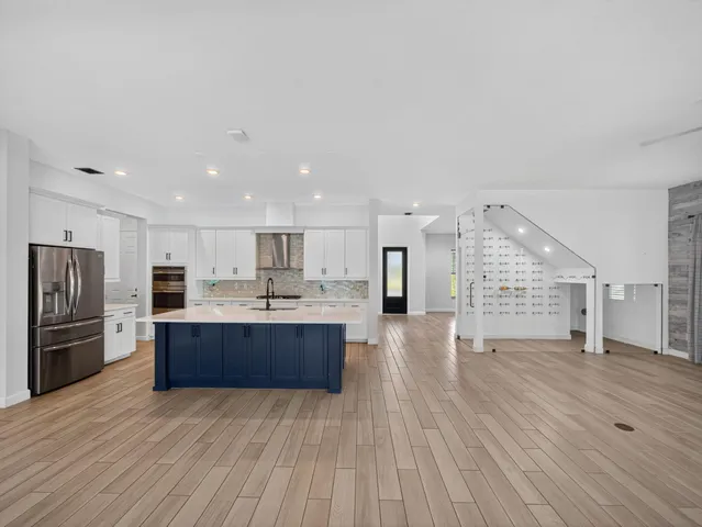 a view of empty room with wooden floor and fireplace