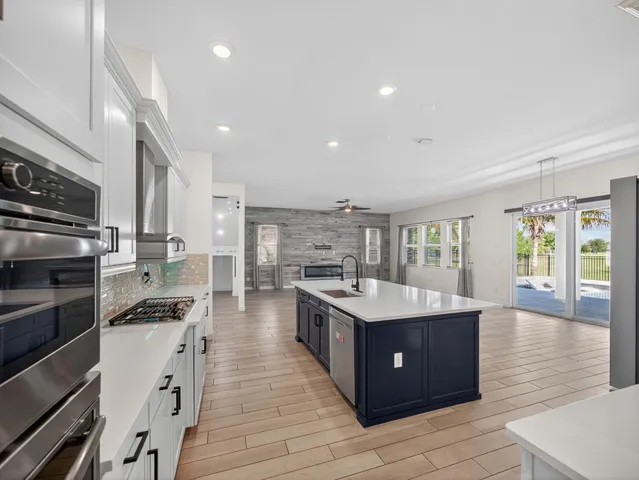 wooden floor fireplace and windows in an empty room